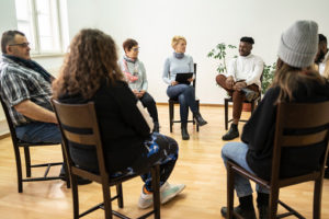 Shows group of people sitting as an example of codesign in action