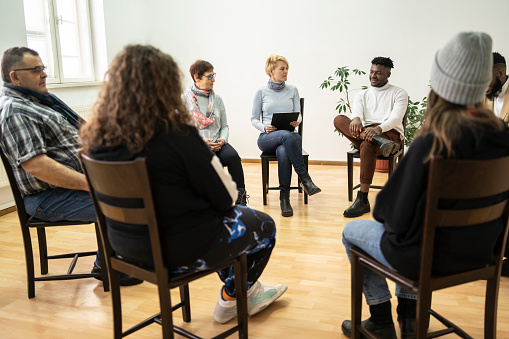 Shows group of people sitting as an example of codesign in action
